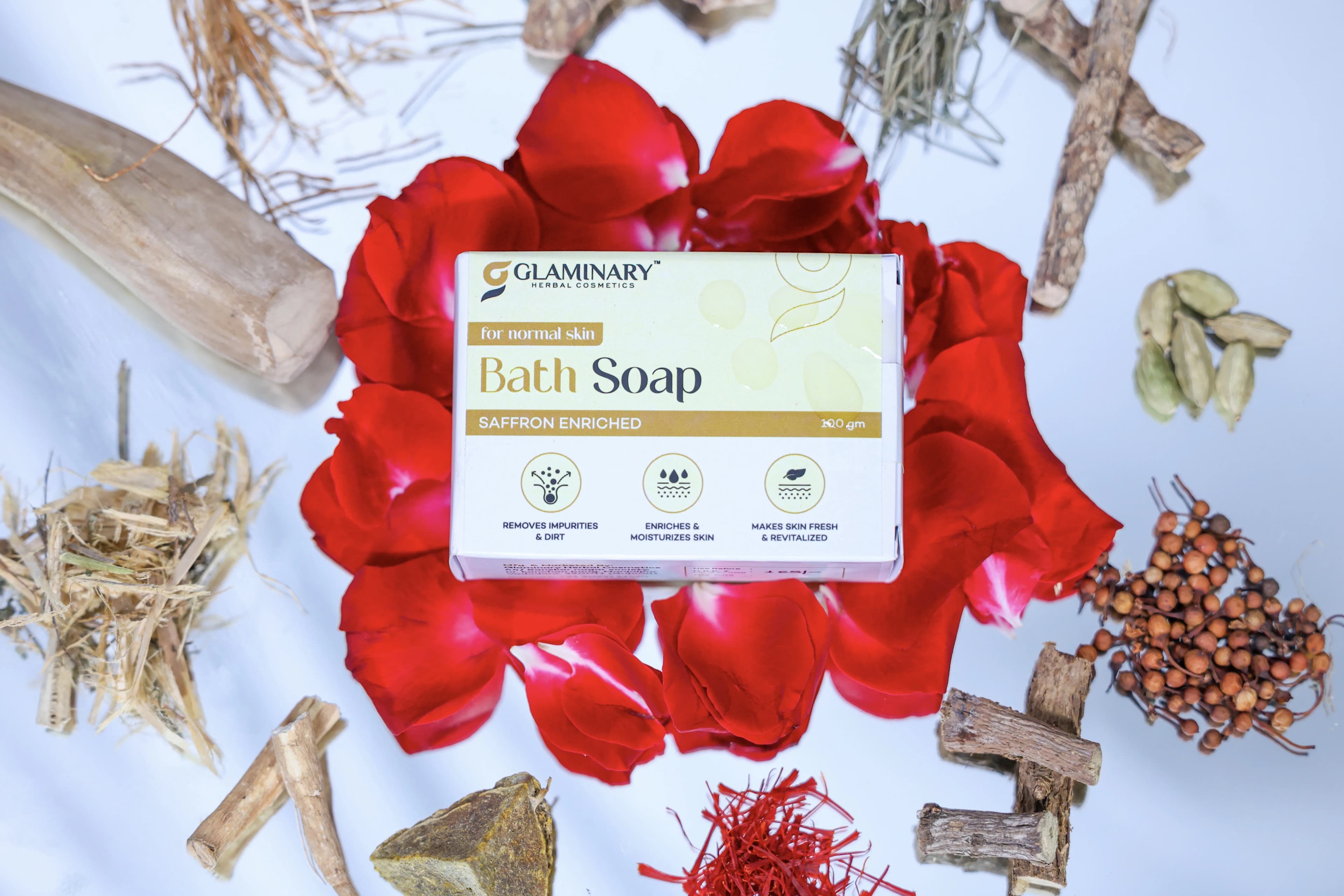 Glaminary Bath Soap box on rose petals surrounded by dried herbs, cardamom and saffron